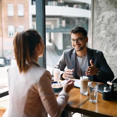 couple discussing and establishing relationship rules to prevent cheating while having coffee