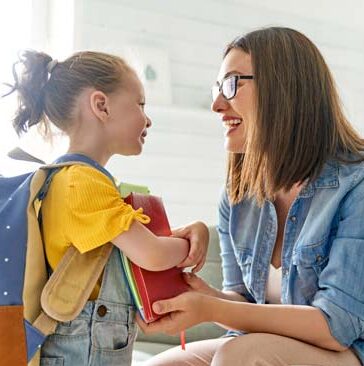 step parent and preschool child getting ready for school