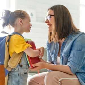 step parent and preschool child getting ready for school