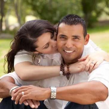 Affectionate happy couple expressing positive feelings towards one another in the Park