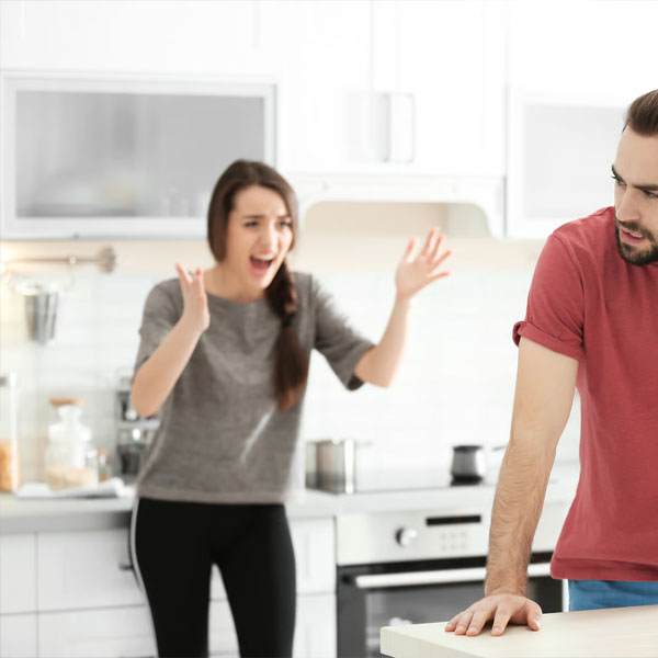 woman screaming at her husband verbally abusing him while he looks fed up