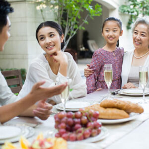 husband wife and in-laws enjoying a meal together