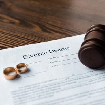 divorce paperwork and couples wedding rings